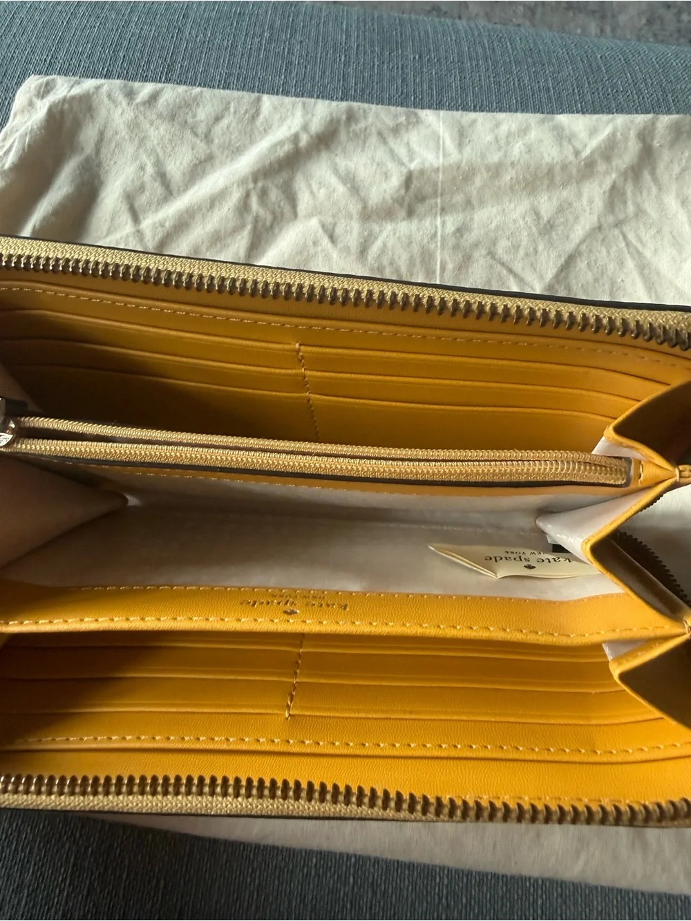 kate spade New York yellow zip-around pebbled leather wallet